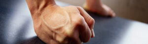 Close-up of a clenched fist focusing on skin texture and veins.